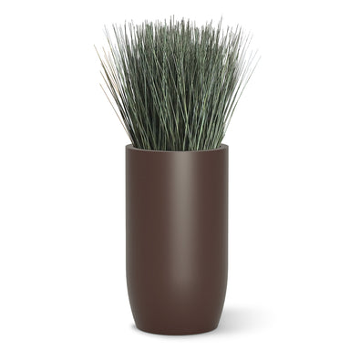 Botanical design with cortada grass in a brown fiberglass barrel.