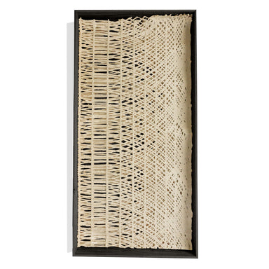 Decorative paper in a black shadowbox frame.