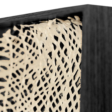 Close-up of a framed piece of art paper with a lattice pattern.