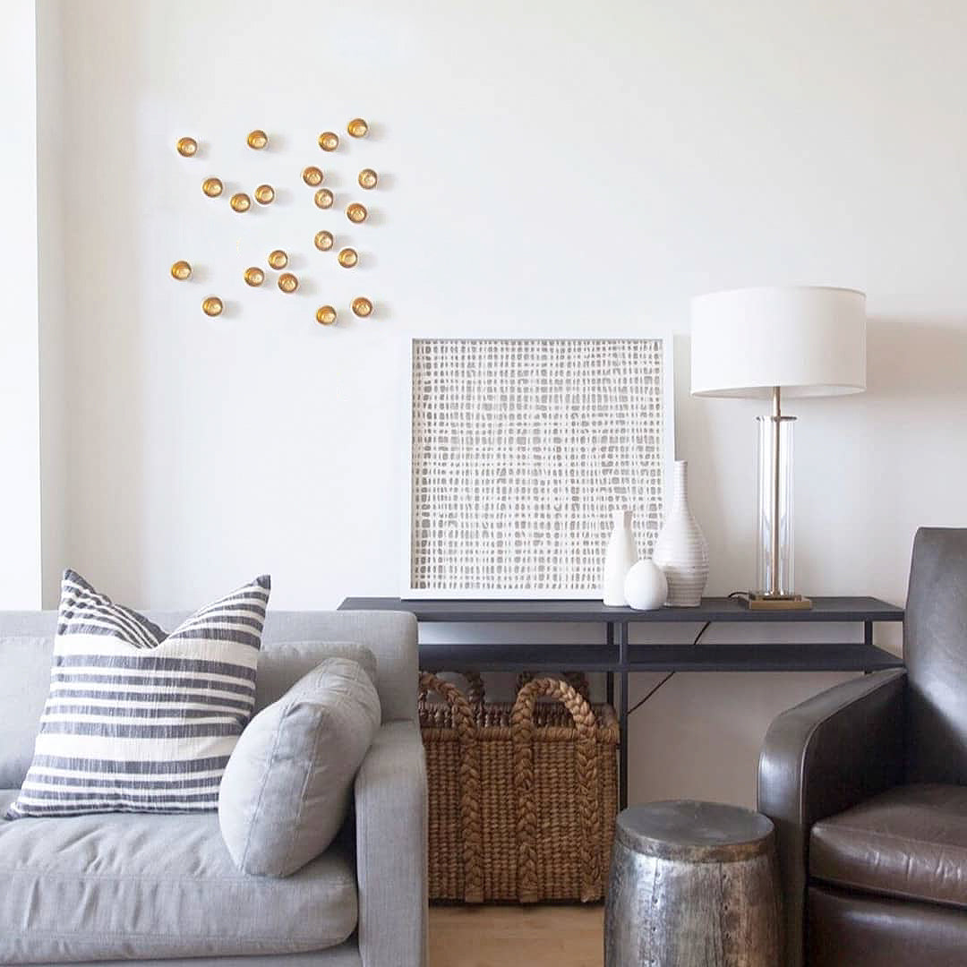 Gold Seed Wall Play by a white artwork in a Livingroom.