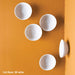Five white resin Full Moon Wall Play on an orange background