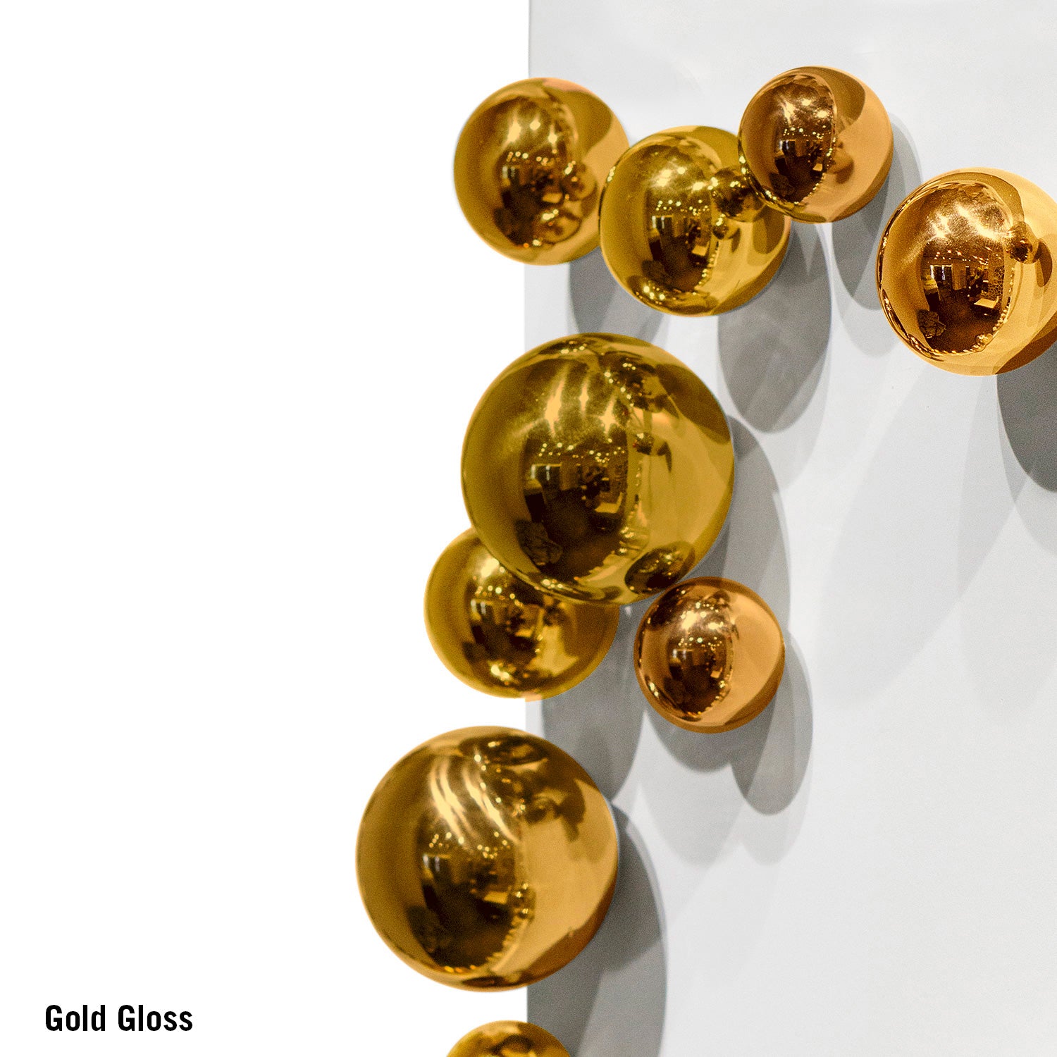 Gold spherical objects on a white background