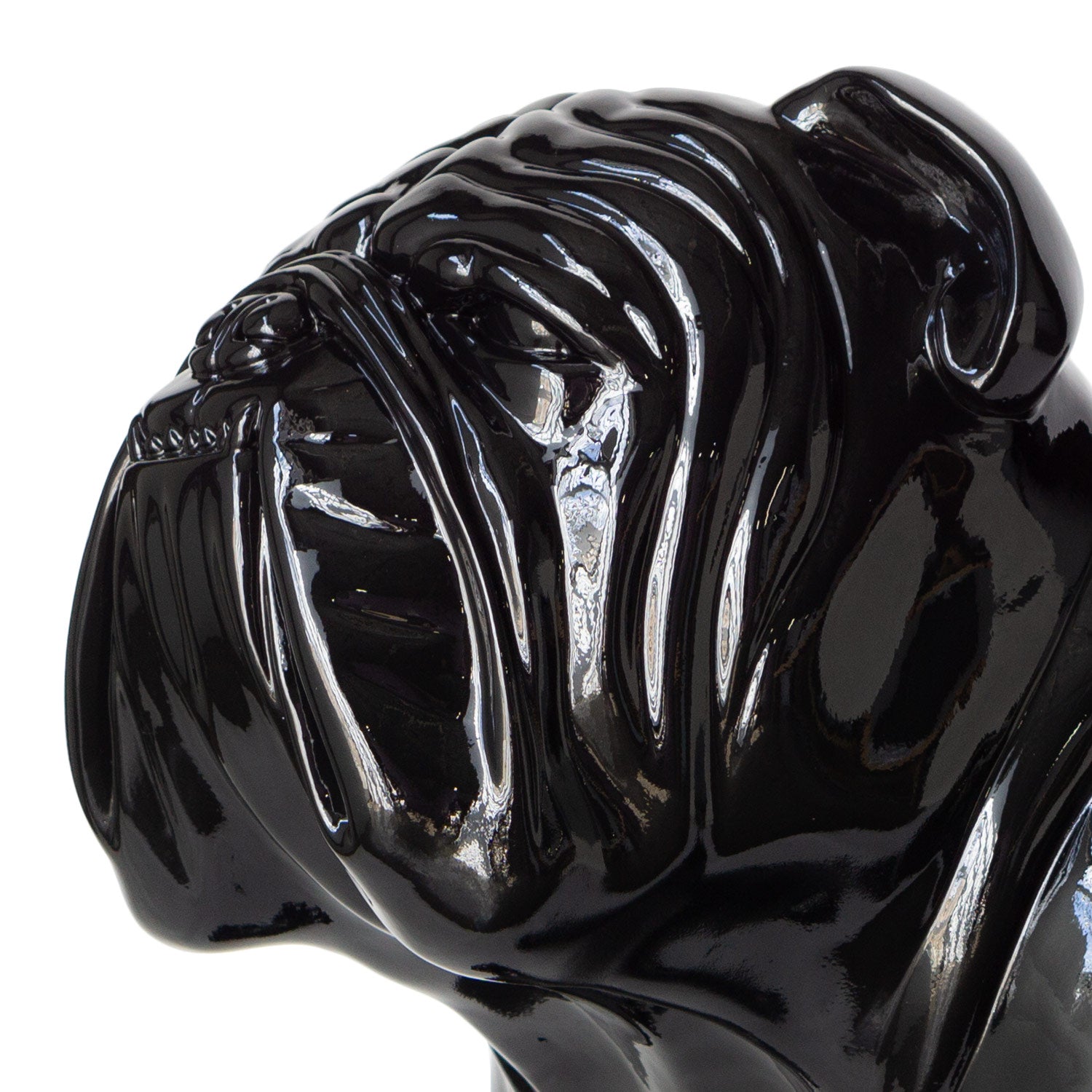 Close up of the face of a large glossy black bulldog sculpture.