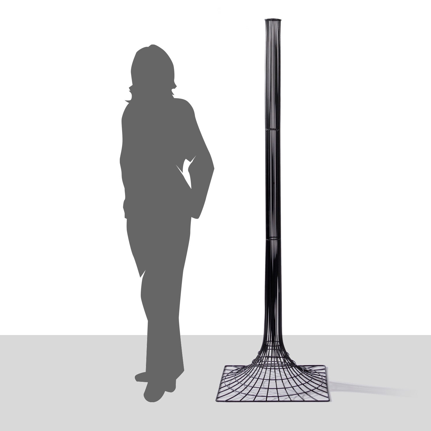 Black Iron Vortex floor sculpture with a silhouette of a person as reference.