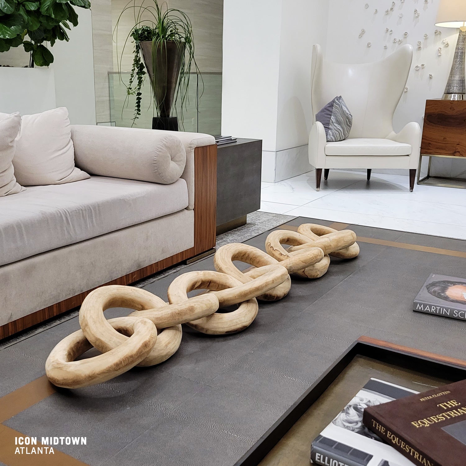 Large Wood Chain on coffee table in luxury apartment lobby.